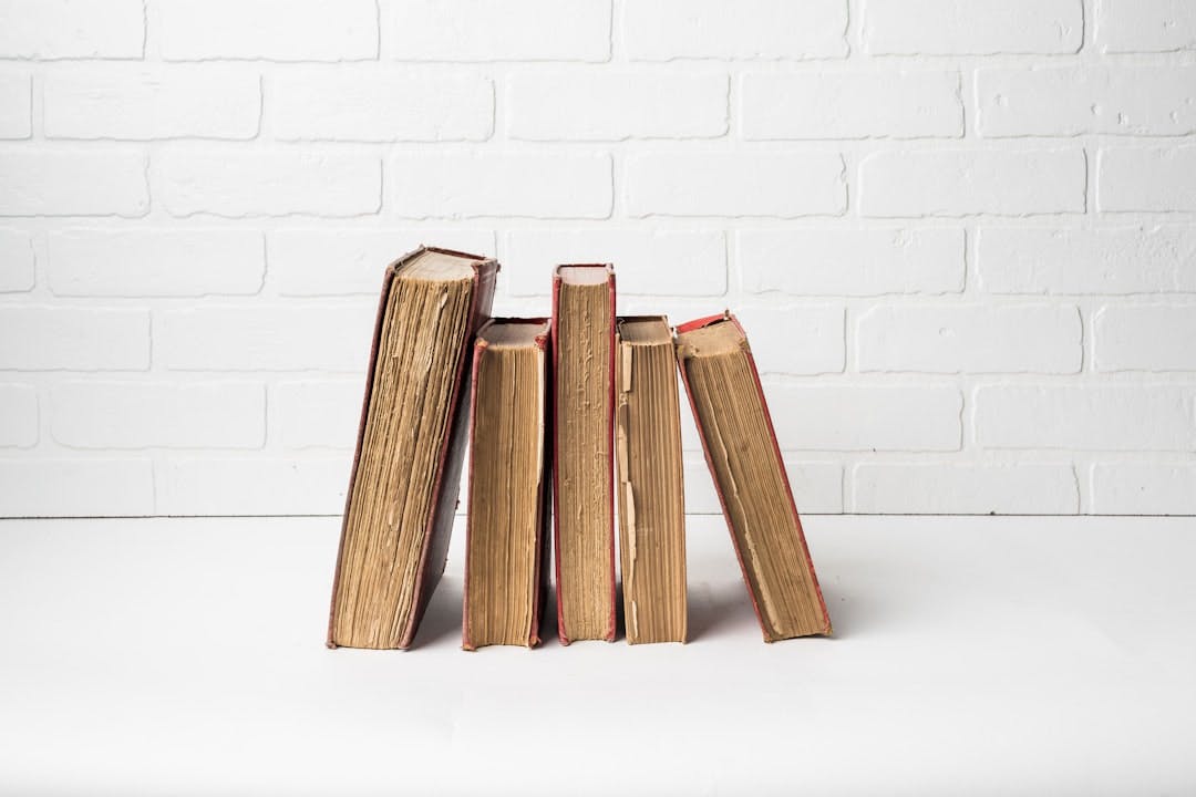 a stack of books sitting on top of a white table